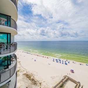 Take in the refreshing salt air from your balcony, overlooking the beach and colorful umbrellas dotting the shoreline below