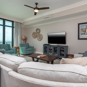 Unwind in the living area, featuring a queen sofa sleeper, enjoying coastal views from the balcony