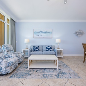 This living room wraps you in cozy recliners and soft cushions while you unwind after a day near the shore