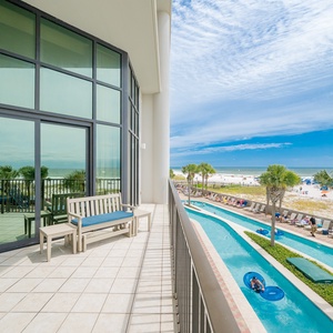 Relax on the balcony overlooking the lazy river and beautiful pristine beach, perfect for a sun-soaked getaway