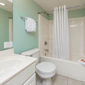Refresh in this bathroom featuring a vanity, soft towels, and a tub-shower for your comfort