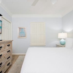 Pillows arranged for rest await in the guest suite with a TV ready for your favorite show