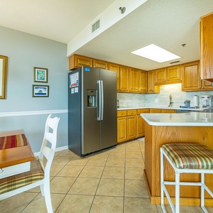 Warm wooden cabinets complement the sleek appliances in this inviting kitchen, ideal for preparing meals during your stay