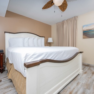 Relax in this cozy master bedroom featuring a plush king bed, elegant decor, and warm, inviting tones