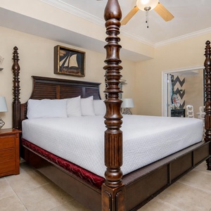 Relax in this elegantly decorated master suite featuring a grand four-poster king bed and a view of the adjoining dining area