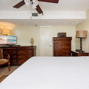 Rich wood furniture surrounds your king suite where you relax and catch up on favorite shows