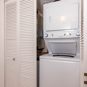 Convenient stacked washer and dryer tucked behind louvered doors, perfect for easy laundry during your stay