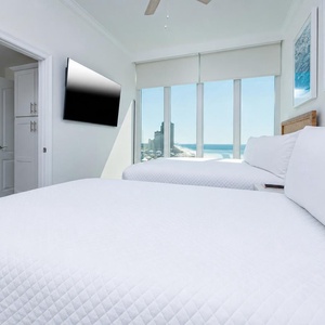 Nestle into the soft queen bed, soak in the gulf view through floor-to-ceiling windows, and relax with a movie