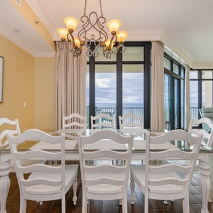 Gather around the elegant dining table, savoring family moments while enjoying the expansive coastal view