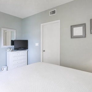 Relax on the cozy queen bed in this guest suite and stream your favorite shows after a beach day