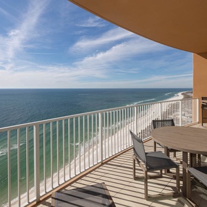 Step onto the sunlit balcony and feel the gulf breeze as you lounge at the table with stunning coastal views