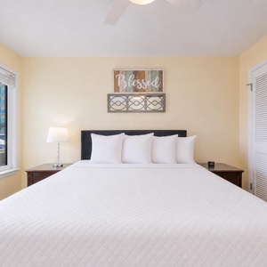 Soft yellow walls surround the queen bed in the master suite where you rest after a day outside