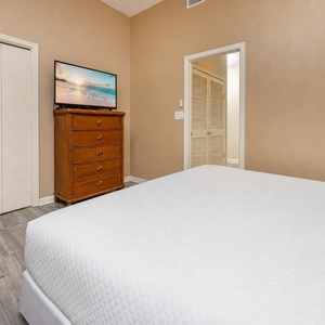Drift off to sleep in soft queen bedding, with a TV ready for your favorite movies in this cozy guest bedroom