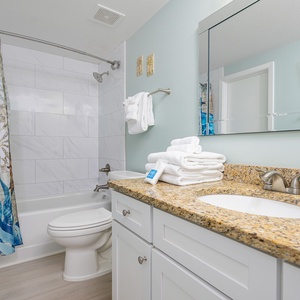 Refresh in this guest bathroom featuring a spacious vanity, decorative accents, and a relaxing tub-shower combination
