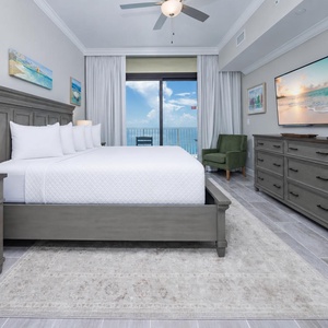 Relax in this master suite featuring a king bed, a large TV, and beachfront balcony access