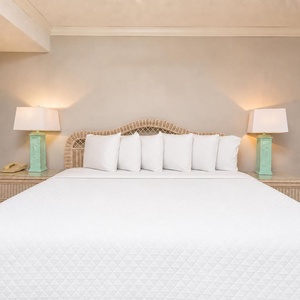 Drift into relaxing sleep on the plush king bed, surrounded by soft linens and fluffy pillows