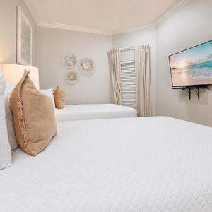 Unwind in the soft queen beds in the guest suite, enjoying favorite shows while soaking in the beach vibe