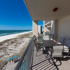 Savor meals at the outdoor table while enjoying the expansive views of the coastline and inviting waters below