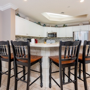 Wake up with morning coffee at the breakfast bar and get ready for a beach day in this stylish space