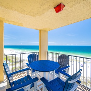 Relaxing view from the balcony overlooking the pristine beach and turquoise waters, with seating