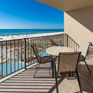 Savor the view from the outdoor balcony area, perfect for relaxing and enjoying the coastal atmosphere