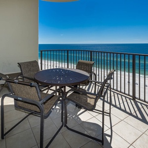 Savor your morning coffee at the round table while taking in breathtaking coastal views from your balcony