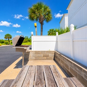 Gather around the picnic table for a fun barbecue experience with grills and a cozy space for family and friends