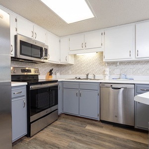Modern kitchen featuring sleek cabinetry, a stylish backsplash, and ample counter space for meal preparation