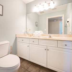 Additional guest half bath with soothing colors and soft towels for convenience during your stay