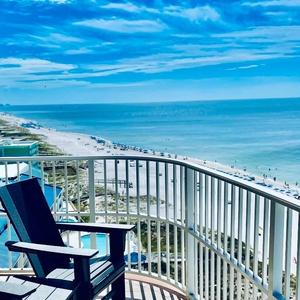 Enjoy your corner balcony on the beach to watch the pool, shore activity, and distant horizon