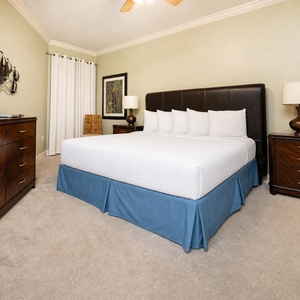 Your king master suite invites deep rest with plush carpet underfoot and soft lamp glow nearby