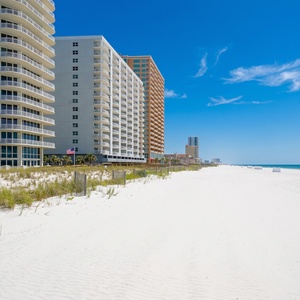 Experience a beachfront vacation at this stylish rental with palm trees and spacious balconies, Sea Glass in Gulf Shores