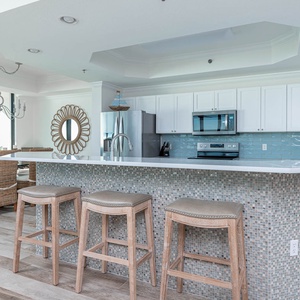 Gather around the stylish breakfast bar with comfortable stools, perfect for casual meals and morning coffee