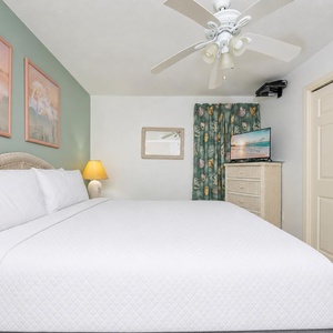 Sink into plush king bed linens in the peaceful master suite where gentle fan breezes whisper above you