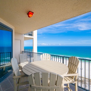 Relax on your balcony as the calming coast stretches beneath a sky painted with wispy clouds and sunshine