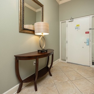 Step into a welcoming entryway with a stylish lamp and mirror that create a warm first impression as you arrive