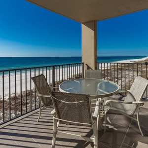 Enjoy meals or morning coffee at the round table on the balcony, with sweeping views of the tranquil beach views