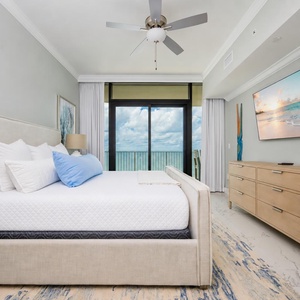 Experience comfort in this inviting master suite with a king bed, coastal decor, and beachfront balcony access