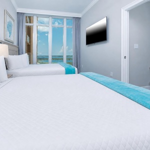 Wake to beautiful views through expansive windows in this guest suite and stream your favorite show to unwind