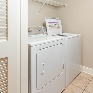 Laundry area featuring a washer and dryer with ample shelf space above for convenience and organization