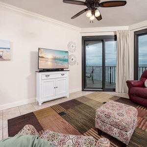 Spacious living area with plush seating, vibrant decor, and a view that invites you to unwind