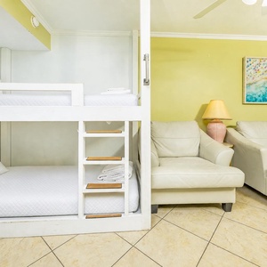 Plush leather seating and crisp bunk beds offer restful spots for family fun and evening relaxation in the living room