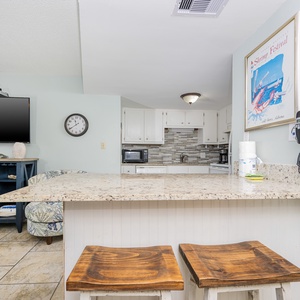 This inviting space features a stylish kitchen with a breakfast bar, perfect for enjoying meals and socializing