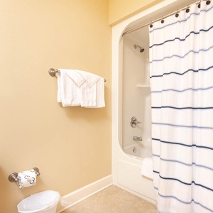 Freshen up in this guest bath in the relaxing shower or soothing tub before an exciting beach day
