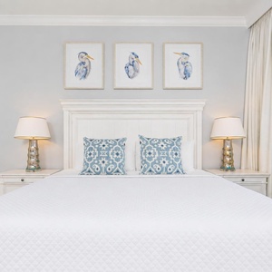 Relax in the master bedroom with a plush king bed, soft lighting, and coastal accents for a restful retreat