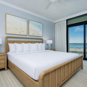 Restful nights come easy in this serene master bedroom with a king bed and beachfront balcony access