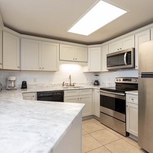 Prepare meals in this inviting kitchen featuring sleek appliances and ample counter space for your culinary adventures