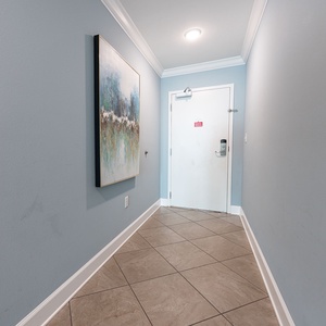 Step into a serene entryway adorned with art, welcoming you to relax and explore your coastal retreat