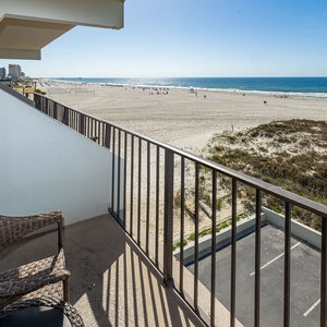 Feel the coastal vibe from your balcony chair as you gaze at the inviting beach and listen to the waves