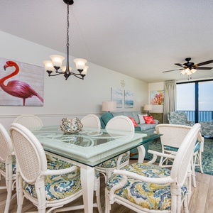 Dine at the glass table surrounded by colorful chairs while enjoying the serene views from the spacious living area